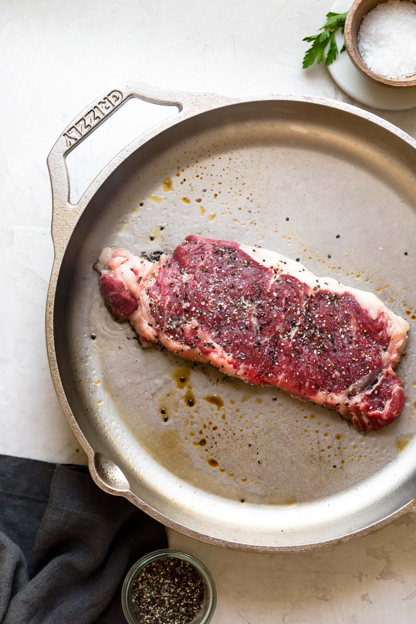 meat cooking on a cast iron skillet